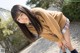 A young woman in a school uniform posing for a picture.