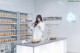 A woman in a lab coat standing in front of a counter.