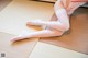 A woman in a pink dress is sitting on a tatami mat.